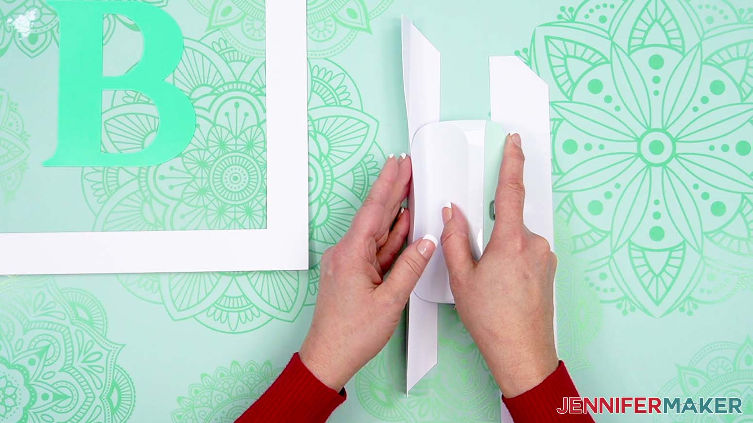 Use a scraper tool to fold the tabs along the crease.