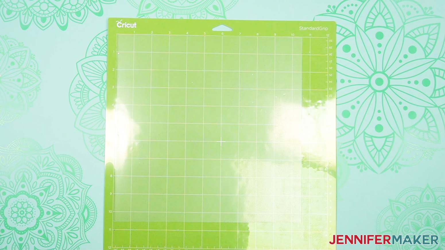 One sheet of acetate on a green machine mat showing the smaller dimensions of the sheet.