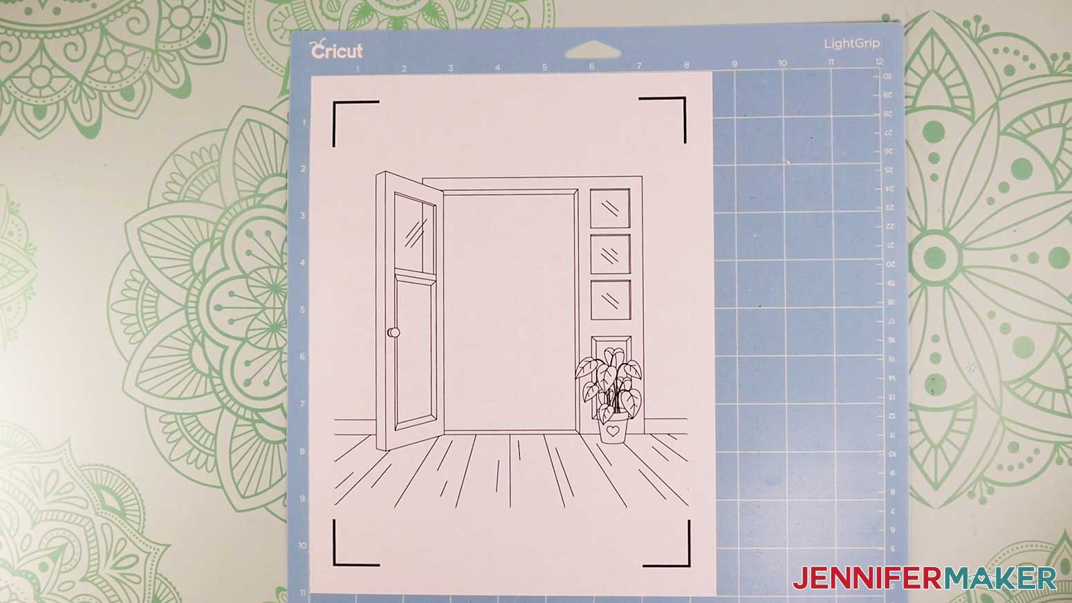 Printed doorway drawing for the light painting shadow box project on a blue LightGrip machine mat