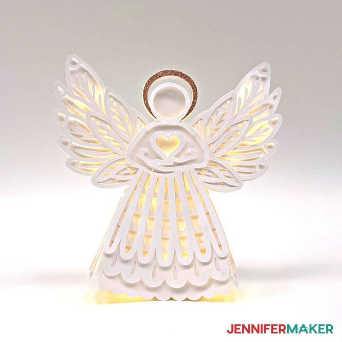 White paper angel with lights on on a white background
