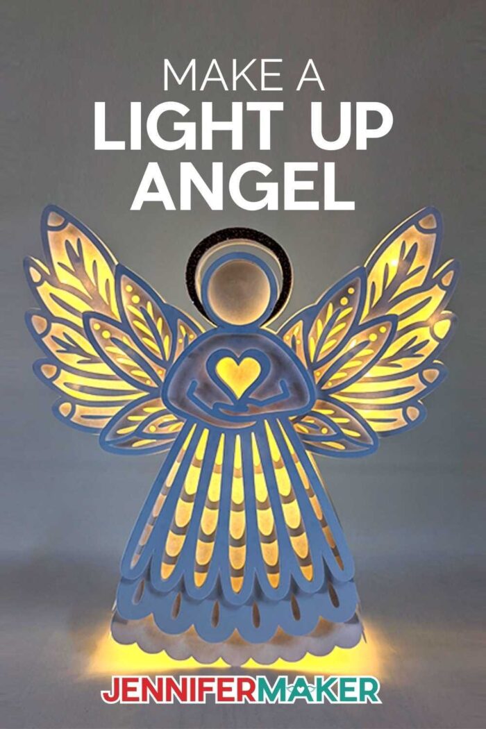 Light up paper angel on a background with lights off