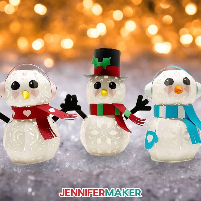 Three 3D light up snowman papercrafts with scarves and cute faces.