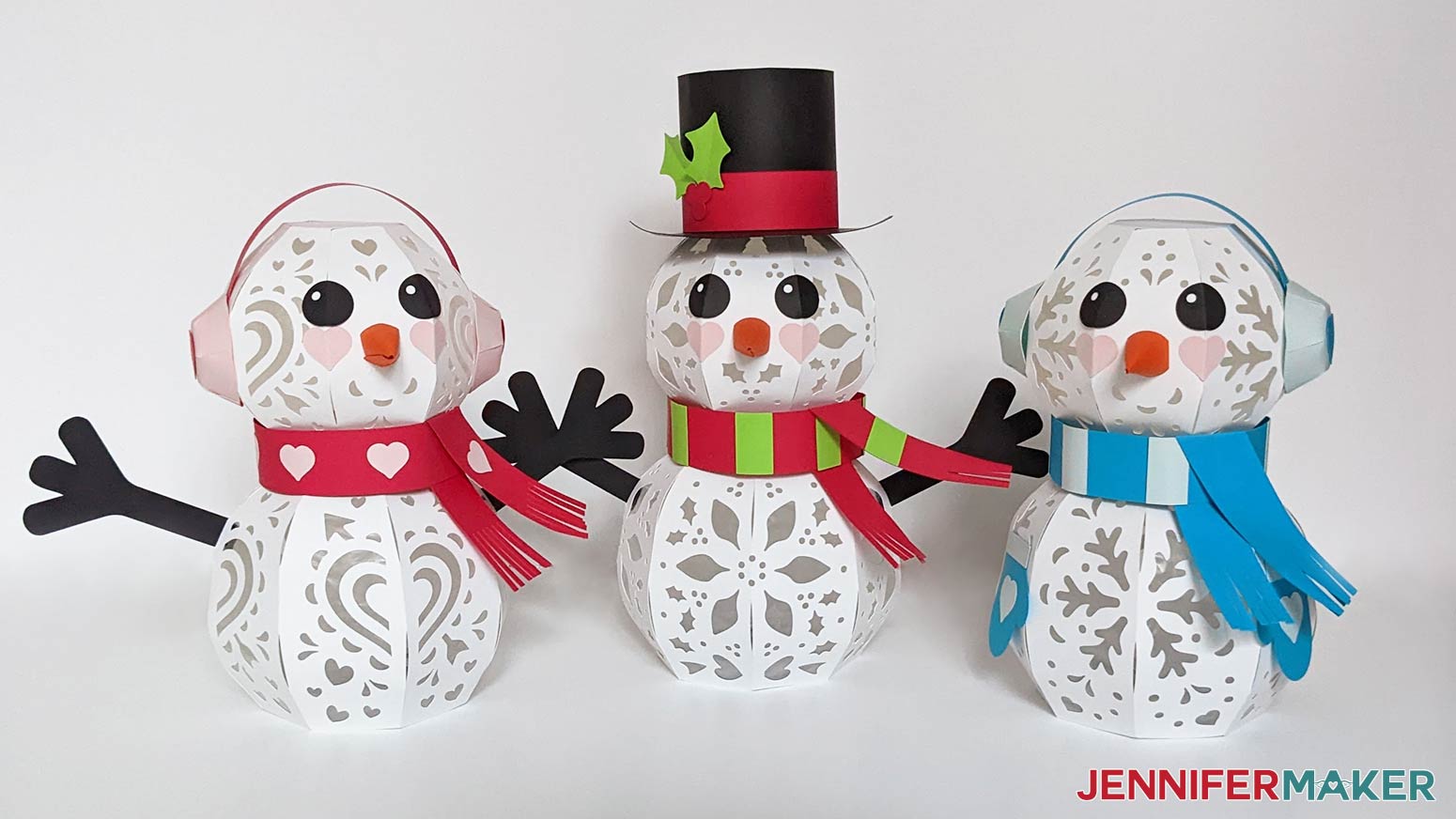 Assembled Valentine's Day, Christmas, and Winter light up paper snowmen placed side by side
