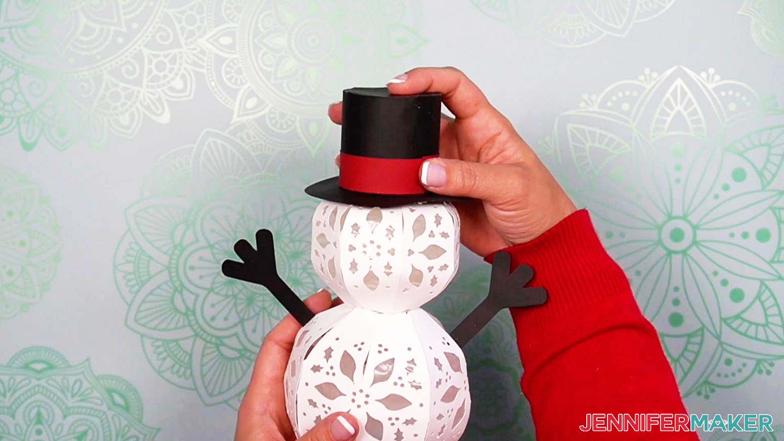 Attach the ribbon piece around the bottom edge of the light up snowman's top hat, so the seam is at the back