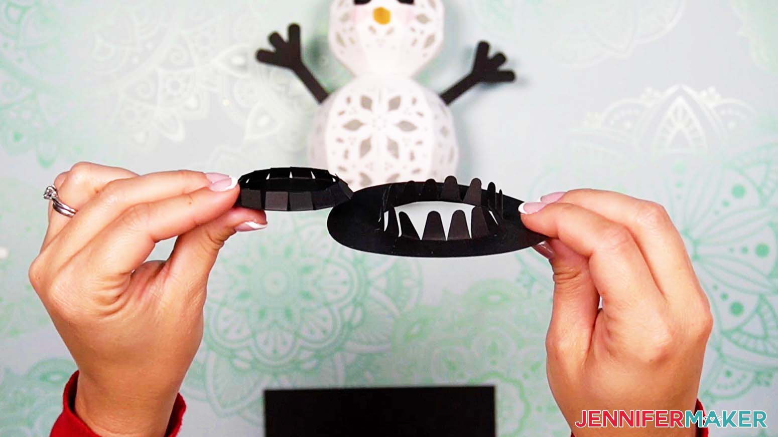 Fold the tabs on the light up snowman's hat brim and top pieces