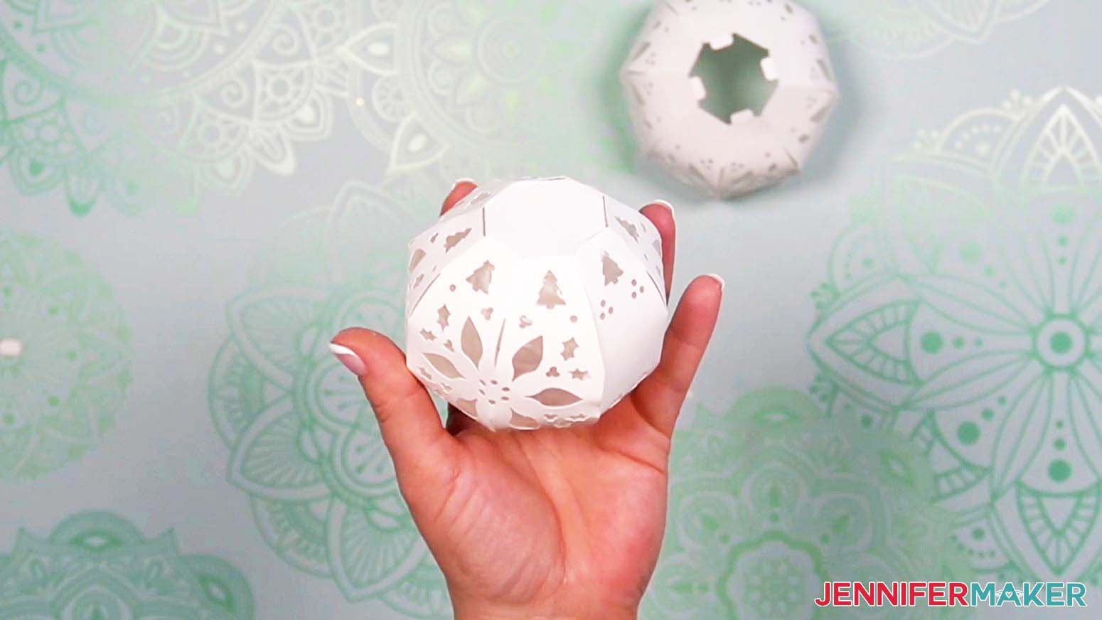 Attach the top piece for the light up snowman's head to the assembled sphere using the four tabs