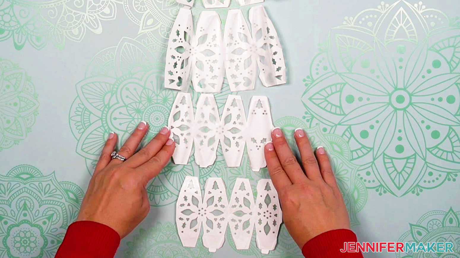 Line up the four wax paper pieces with the four light up snowman's head and body pieces so the edges match up, leaving only a thin border around the outside of each wax paper piece