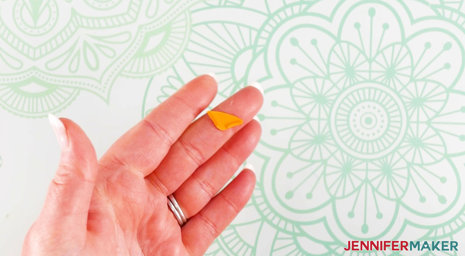 Crafter holding the beak portion of the chick DIY lollipop holder, showing the small sides folded for glueing.