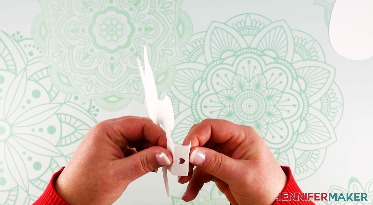 Crafter folding the tab with a hole for the candy stick for the DIY lollipop holder unicorn design.