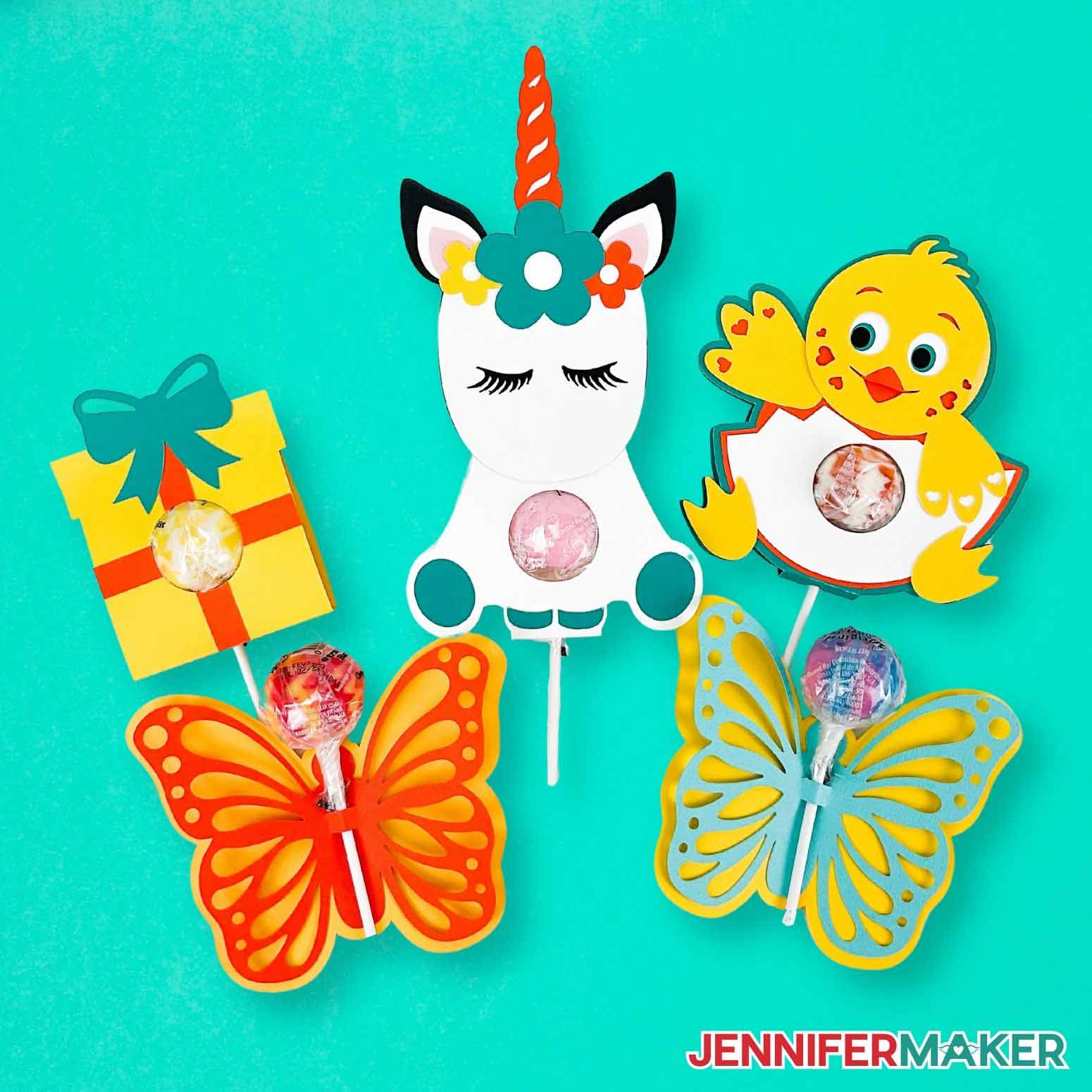 Present, unicorn, chick, and butterfly cardstock lollipop holders on a teal background.