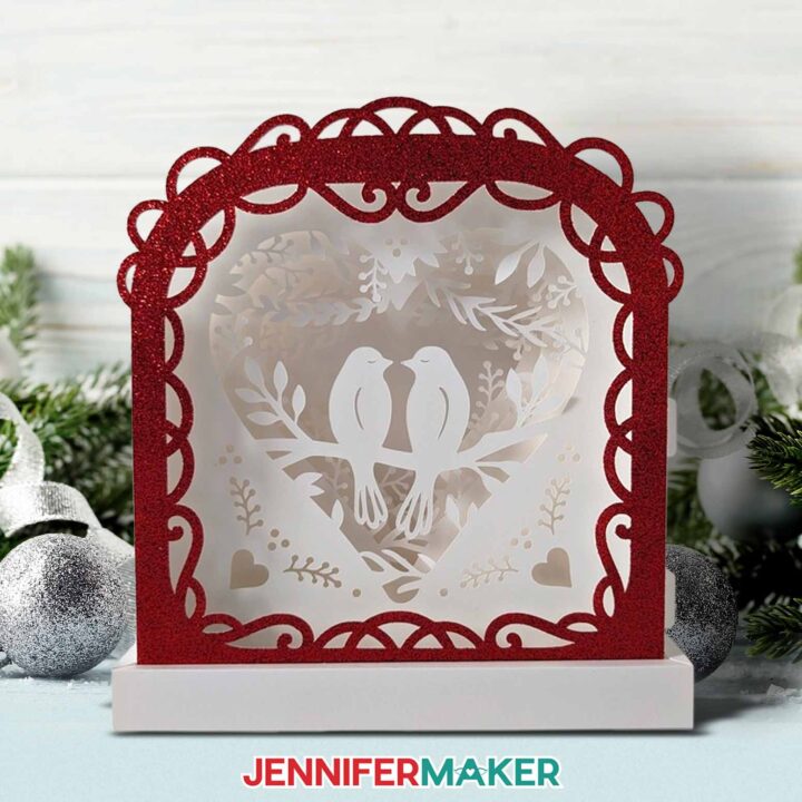 A finished love paper lantern with two birds and a red glitter frame