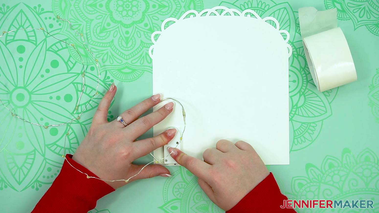 Adhere the fairy lights battery pack to the back piece for the love paper lantern