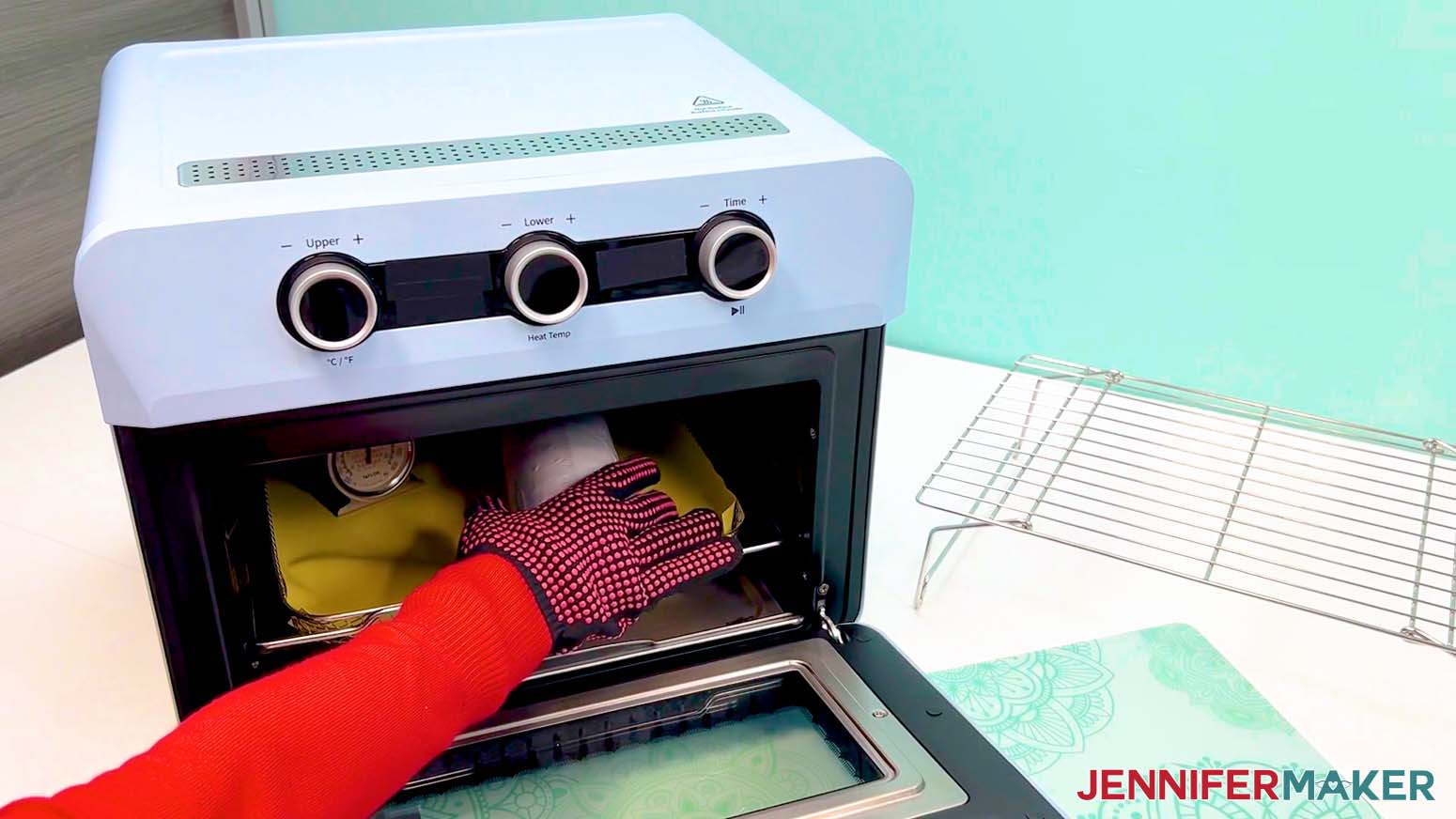 Place the shrink wrapped sublimation design tumbler into the heated oven.