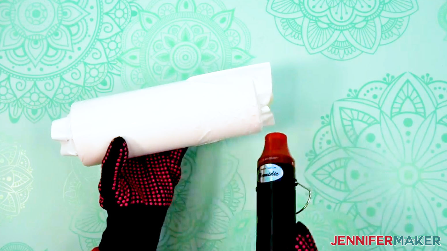 Use a heat gun to shrink the plastic wrap to the prepared sublimation design tumbler.
