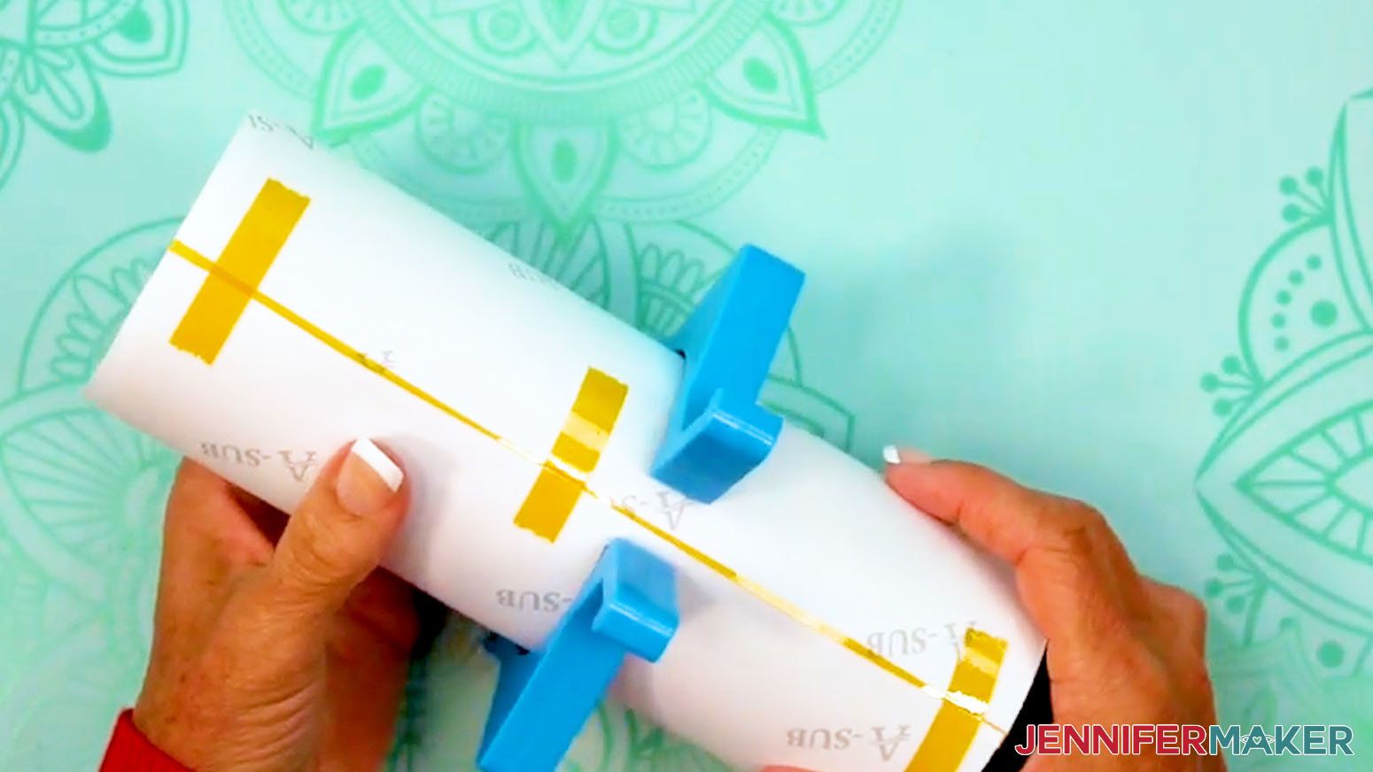 Secure the design into place with short pieces of tape pulled across the seam of the sublimation design tumbler.