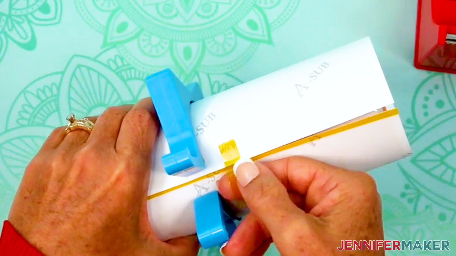 Lightly place a piece of tape onto one side of the seam on the sublimation design tumbler.