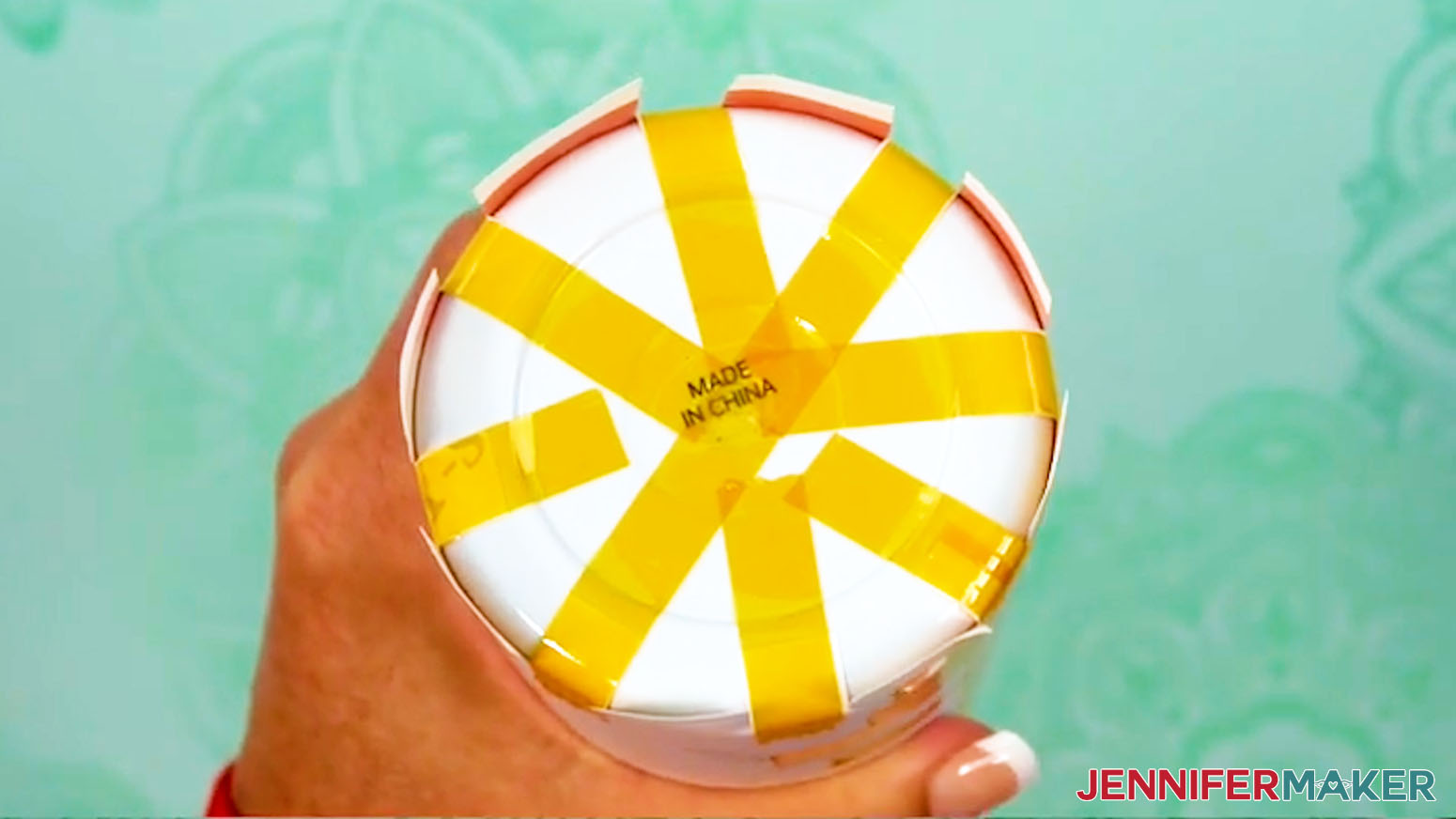 Secure all 8 pieces of tape to the bottom of the sublimation design tumbler.