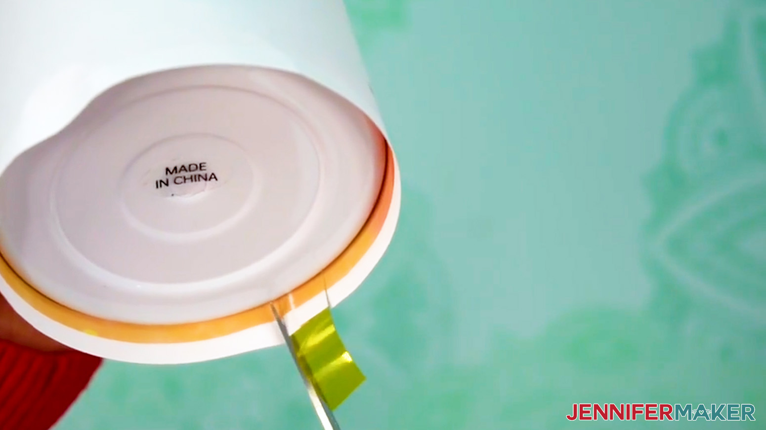 Cut the bottom edge of the sublimation tumbler design print on either side of the tape placed at the bottom.