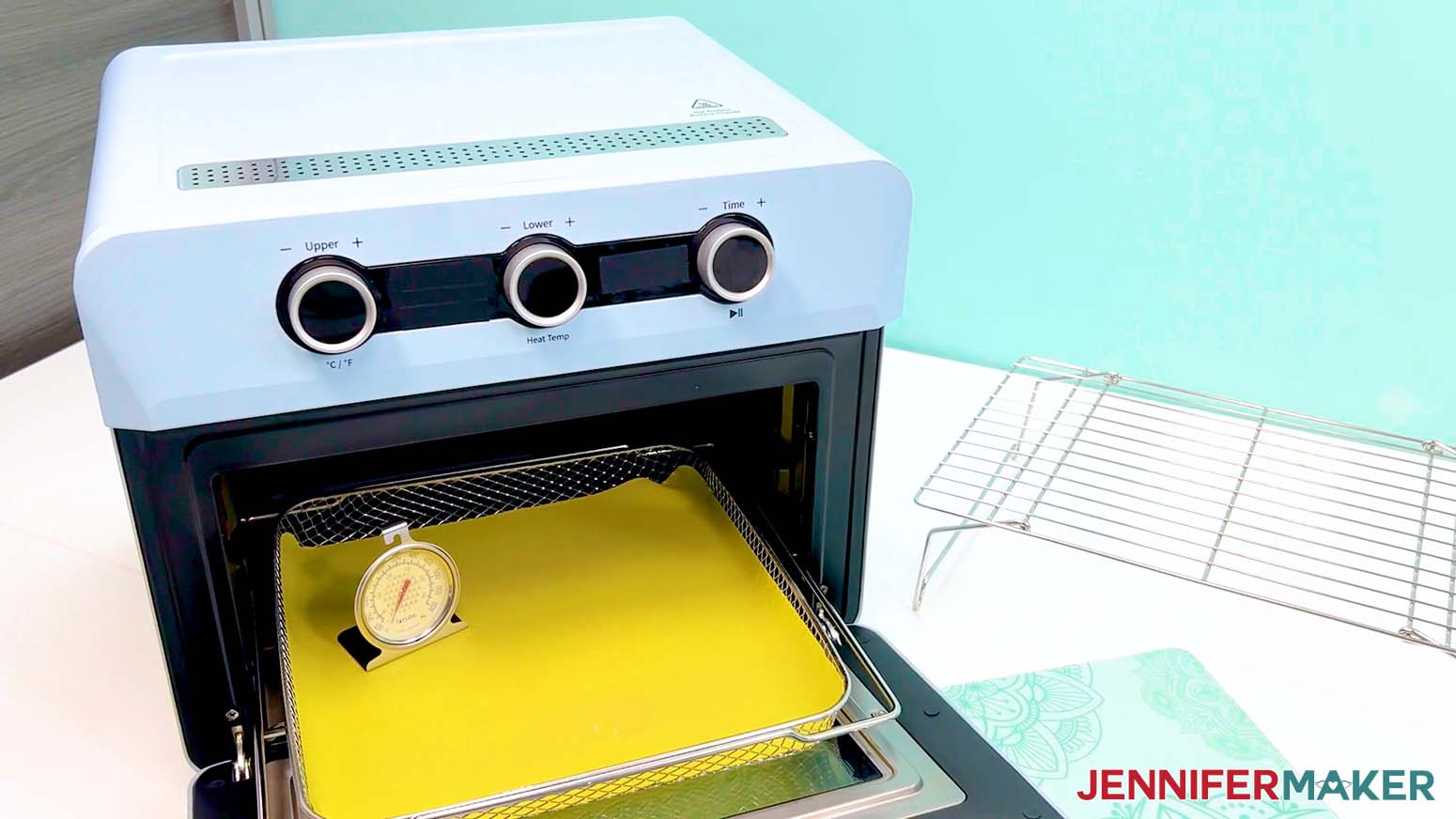 Place a thermometer in the oven to ensure the right temperature for making the sublimation tumbler design.