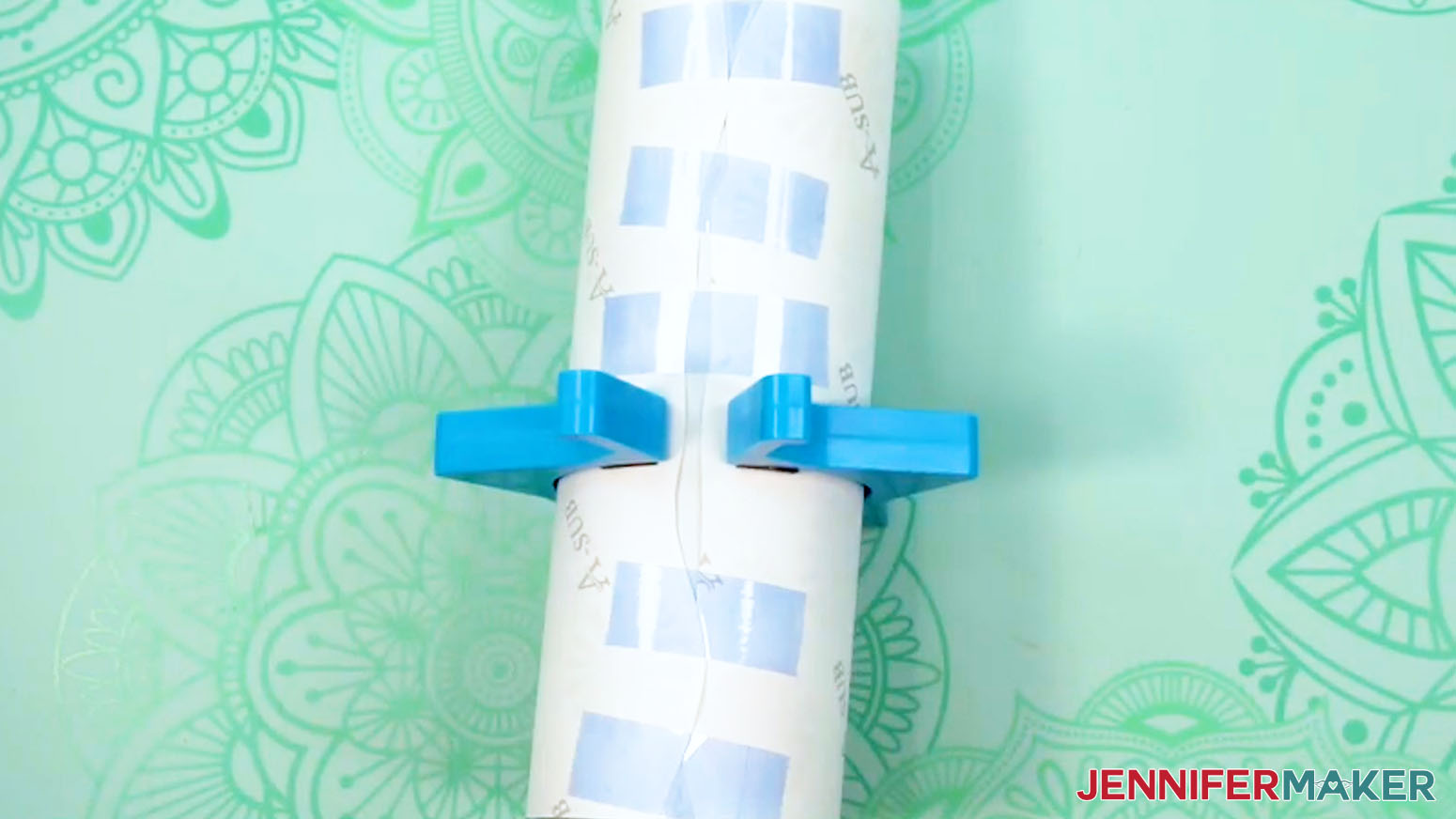 Place several pieces of tape across the uneven seam of the sublimation tumbler design to secure it to the tumbler.