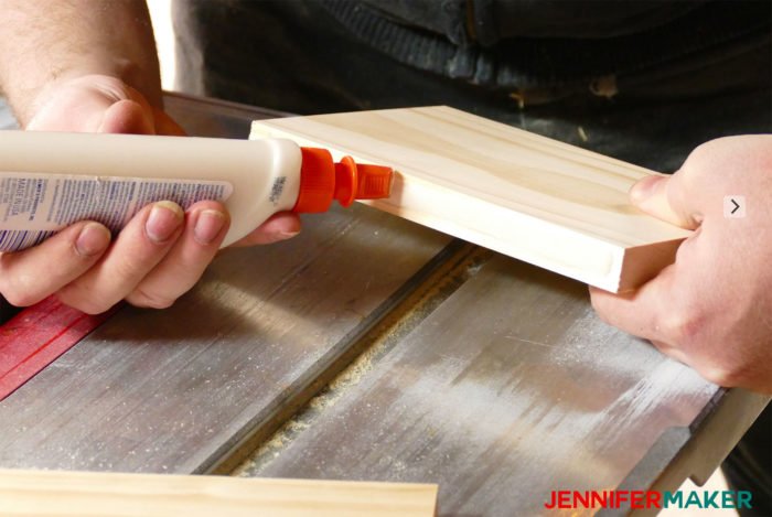 Gluing the birdhouse base together with wood glue