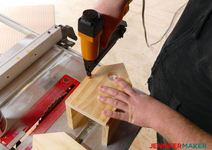 Nailing the walls of the DIY birdhouse together