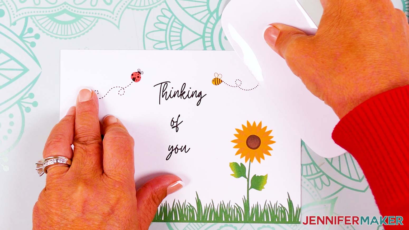 Fold the card in half and use a scraper tool to crisp the crease.