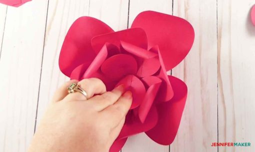 Gluing in the four small petals to the center of the giant paper flower