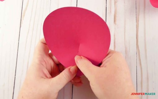 Cupping the large pink paper petal