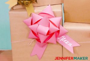 A big pink paper bow made with a Cricut