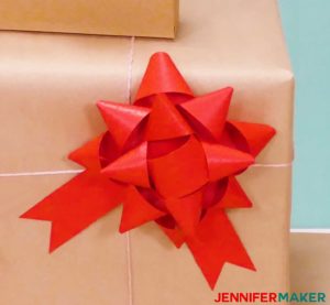 A red paper bow made with a Cricut