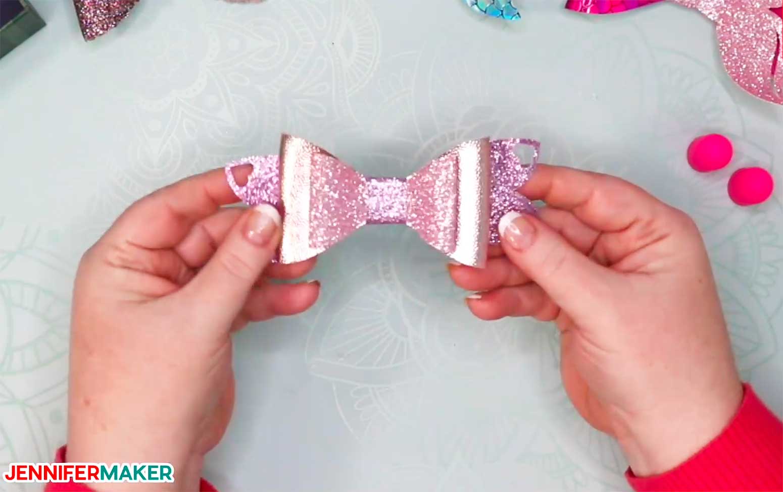 A pink glitter faux leather hair bow made on a Cricut!