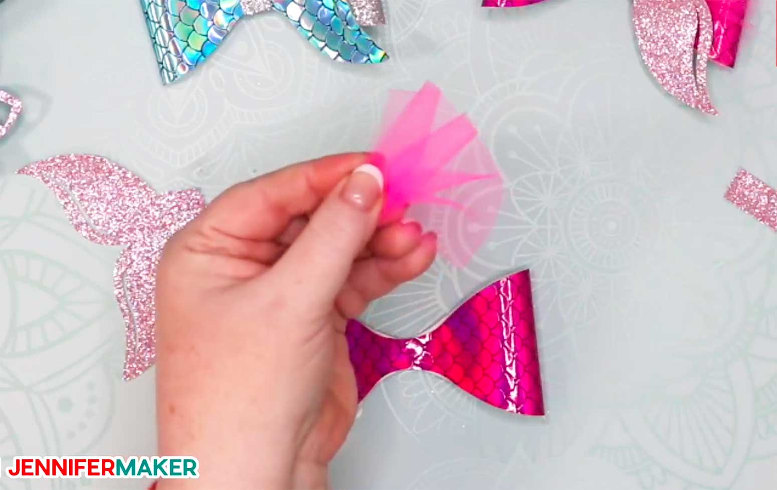 Pink tulle folded in a fan shape to make hair bows with mermaid tails