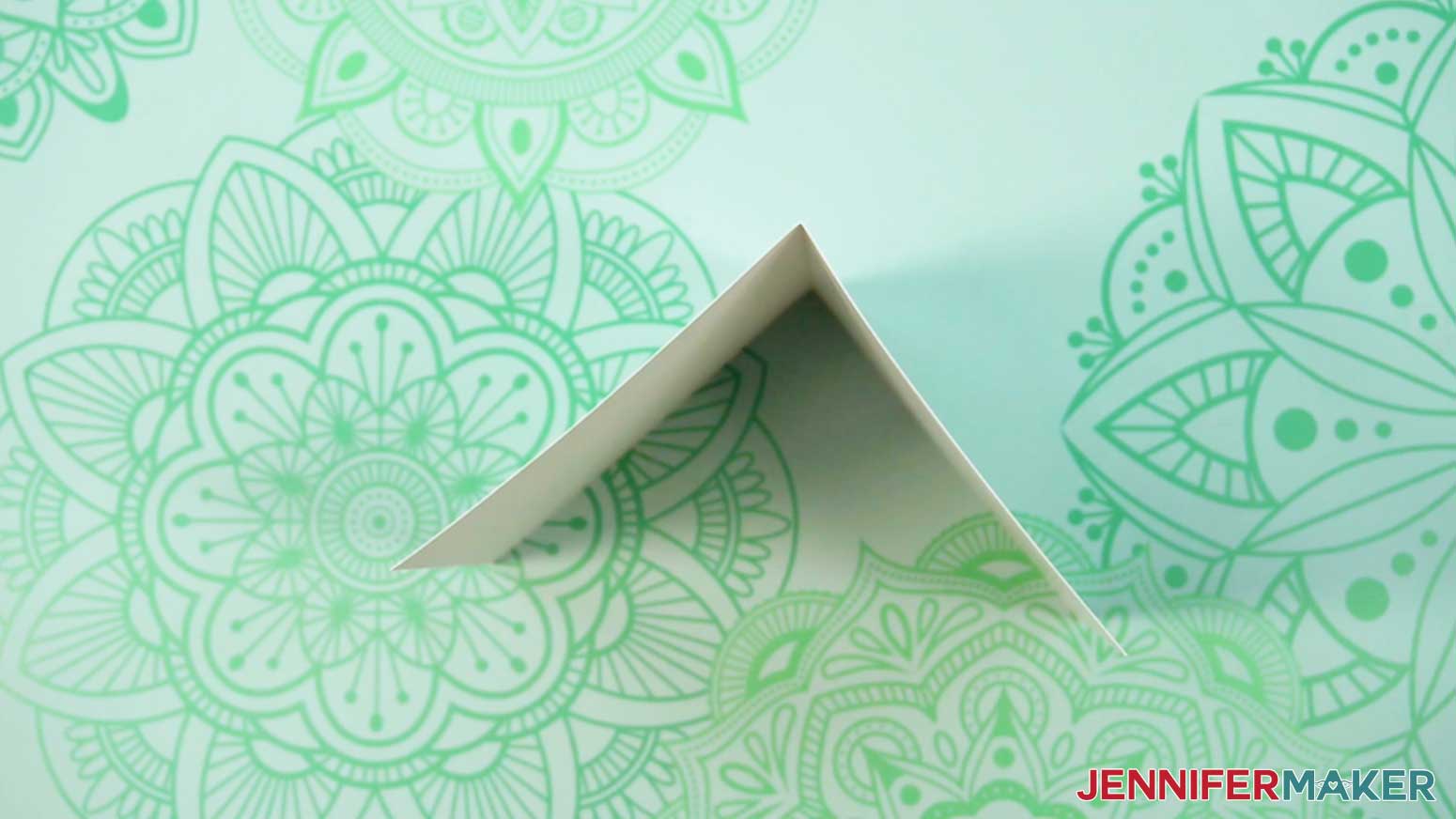 Crease the base Junk Journal page into a mountain fold in the middle on the crease line.