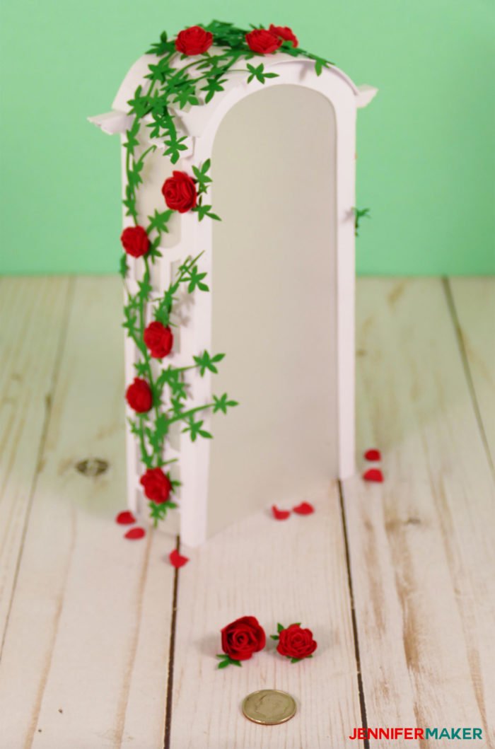 Two dozen miniature paper roses on a paper arbor arch