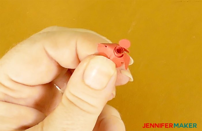 Pulling a miniature paper rose off the quilling tool