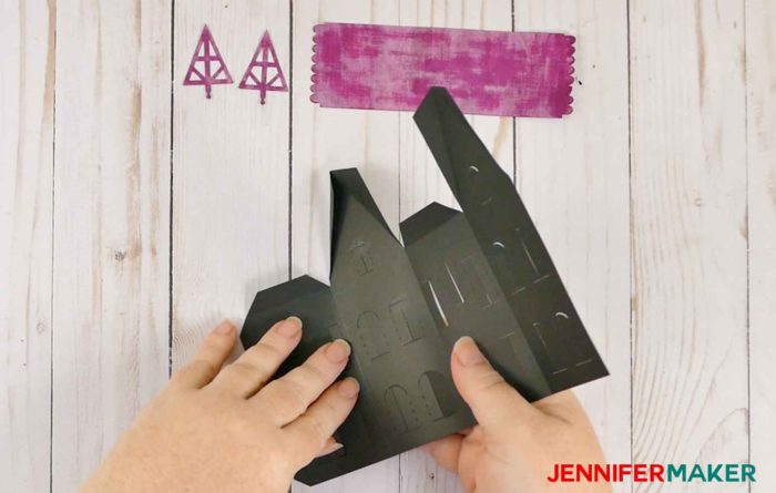 Fold the black paper to make paper haunted houses and a village