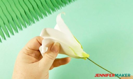 Inserting floral wire into the bottom of your paper lily flower