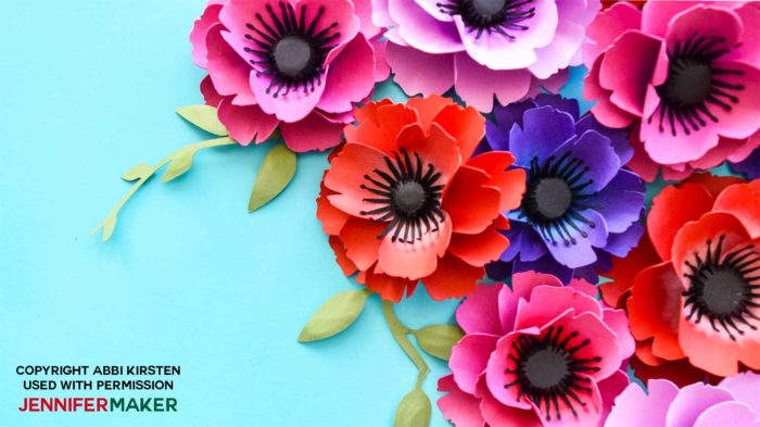 A finished group of paper poppy with a dark stamen and green leaves