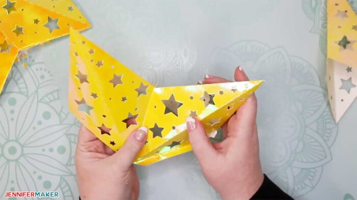 Attaching one star point to another to make paper star lanterns