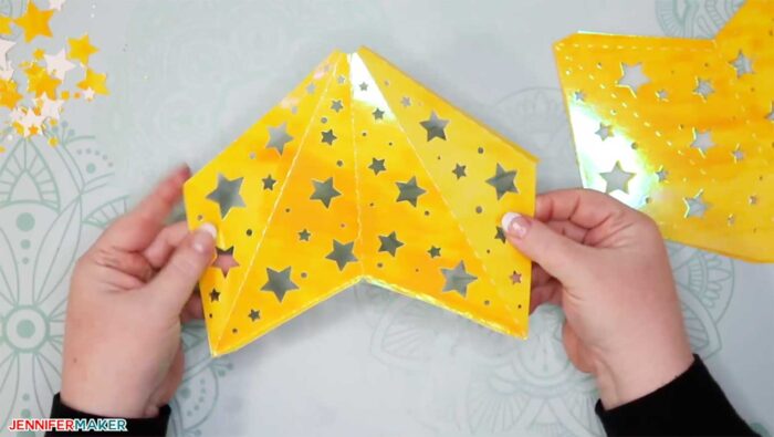 Folding yellow paper to make paper star lanterns