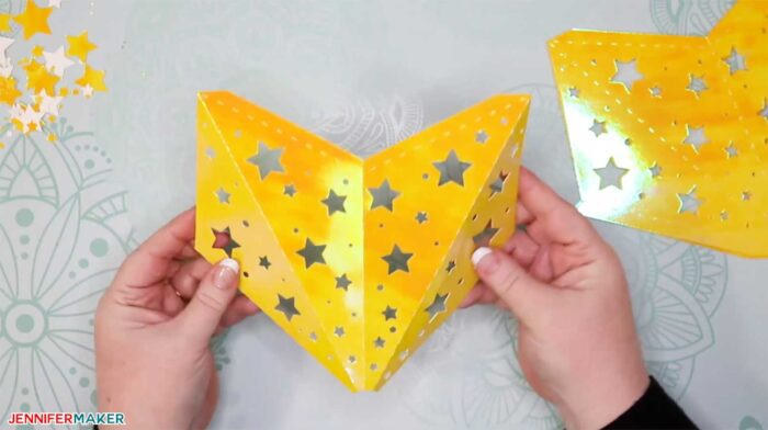 Folding yellow paper to make paper star lanterns