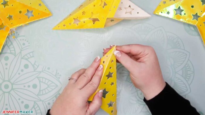 Gluing a tab to make paper star lanterns