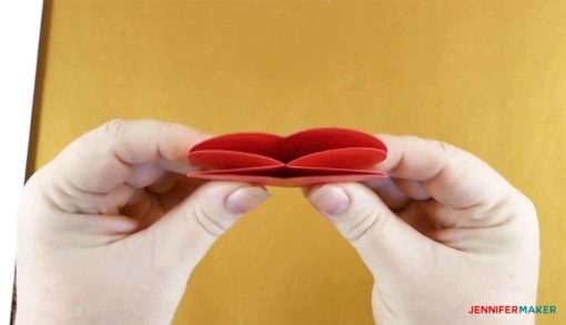 Folding the heart piece into itself to make the pop up heart rainbow card