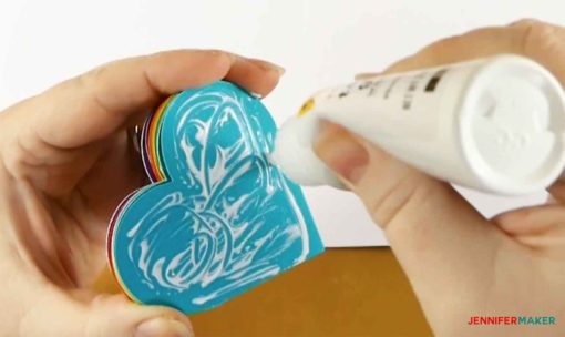 Gluing one end of the folded hearts for the pop-up heart card