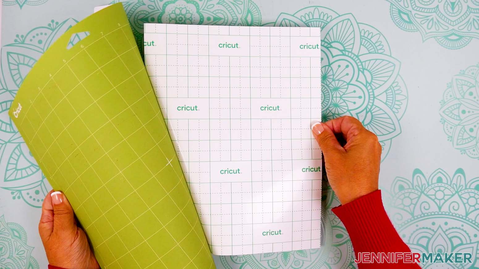 The green mat is being curl backward to release the sticker sheet from it.