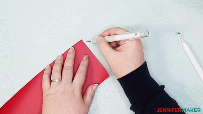 Cutting a corner in a piece of iron-on vinyl to make it easier to weed