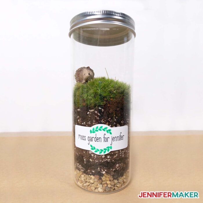 Example of mason jar gift ideas of a terrarium labeled moss garden for Jennifer.