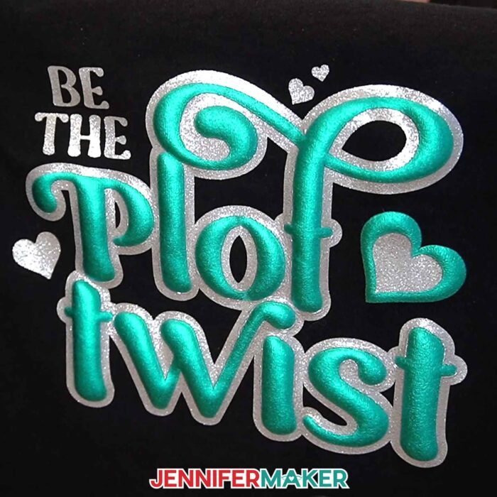Silver glitter vinyl layered under turquoise puff vinyl decorate a black shirt, with the quote "Be The Plot Twist" from the Puff Vinyl Tutorial