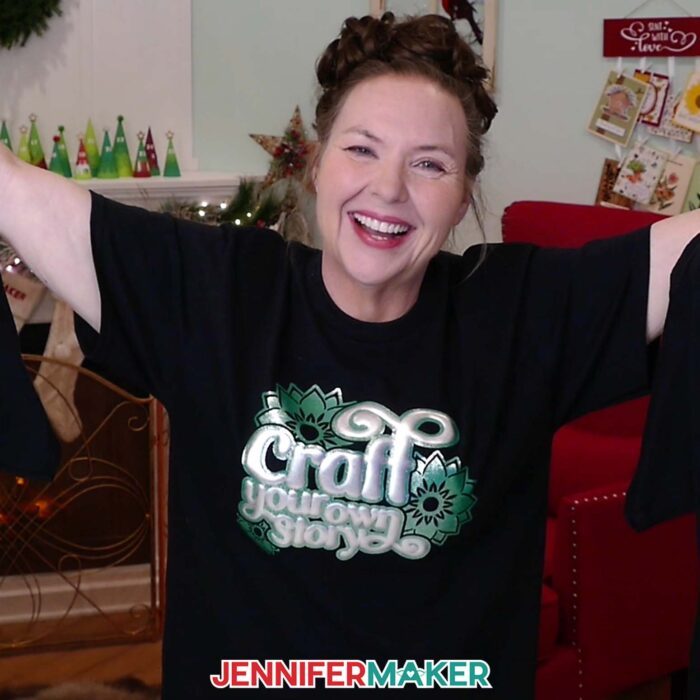 Jennifer Maker wears a puff vinyl T-shirt with the quote "Craft Your Own Story," arms up in excitement, as part of her Puff Vinyl Tutorial